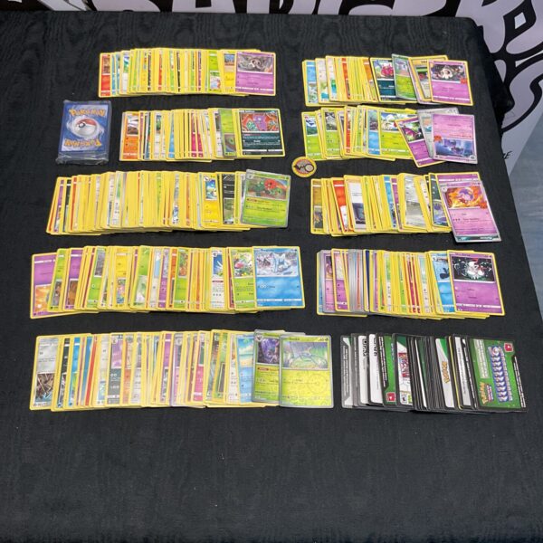 Large lot of mixed Pokemon trading cards with holographic cards.