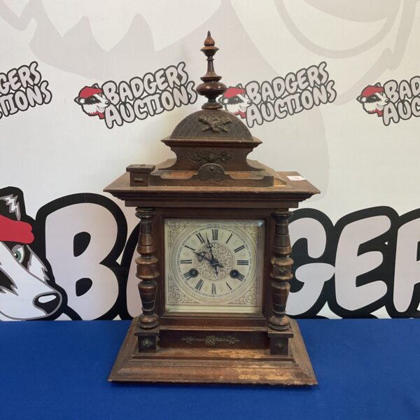 Front view of antique German bracket clock with walnut case.