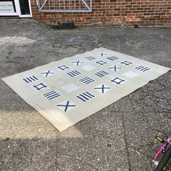 Ikea Gamborg rug with a geometric pattern in neutral tones.