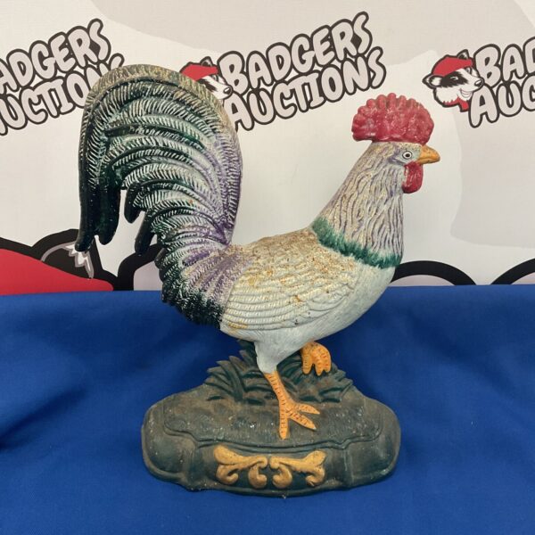 Antique cast iron chicken doorstop with detailed feathering and rustic charm.