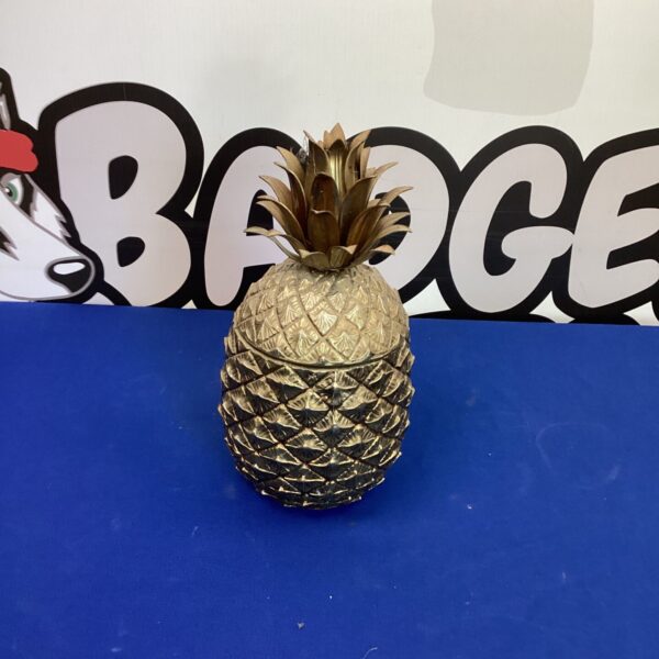 Vintage metal pineapple ice bucket for retro home bar.