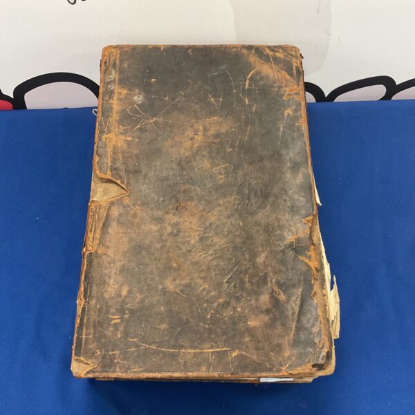 Antique Bible 1832 with worn cover and textured finish.