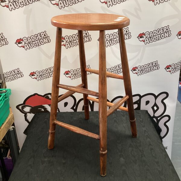 Vintage wooden kitchen stool with three legs for rustic kitchens.