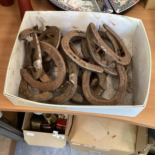 Collection of antique horseshoes, vintage equestrian metalwork.