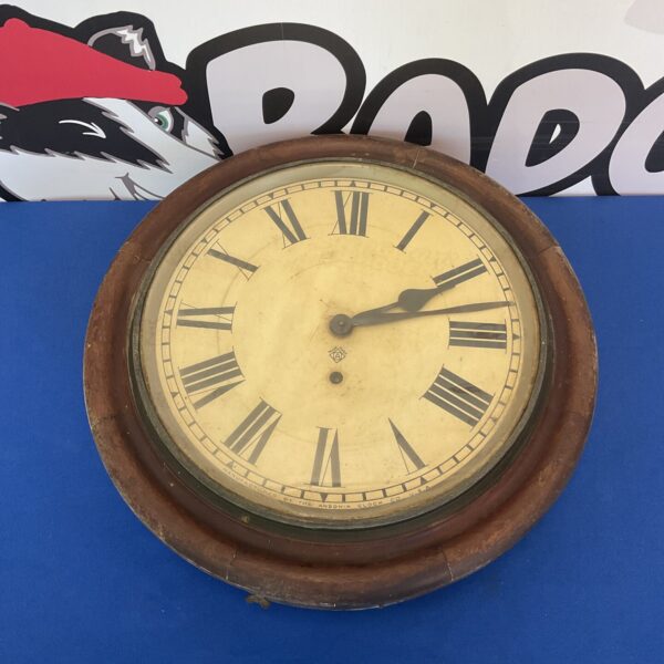 Vintage Ansonia Clock Co wall clock with Roman numerals.
