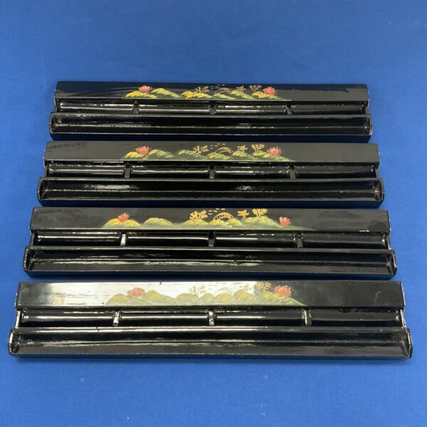 Vintage black lacquered mahjong tile walls for gameplay.