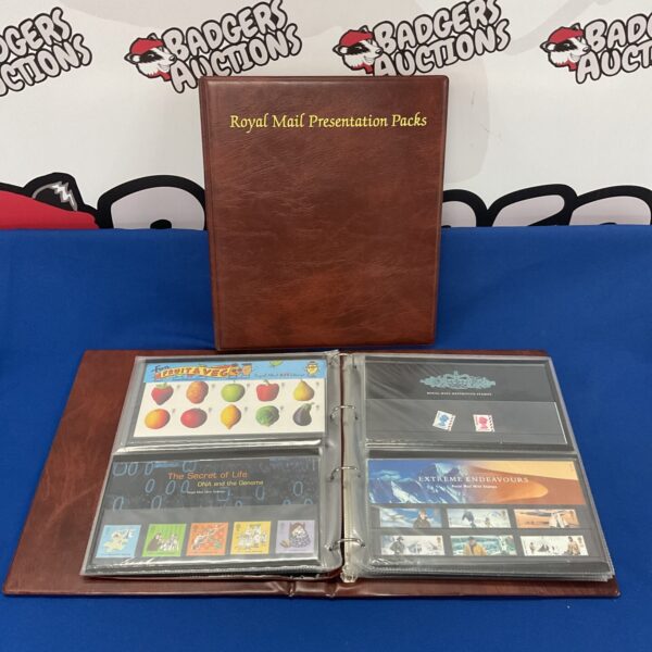 Royal Mail stamp presentation packs in a blue folder.