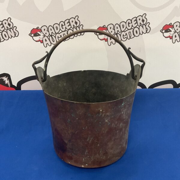 Antique copper bucket with rustic patina for farmhouse decor.