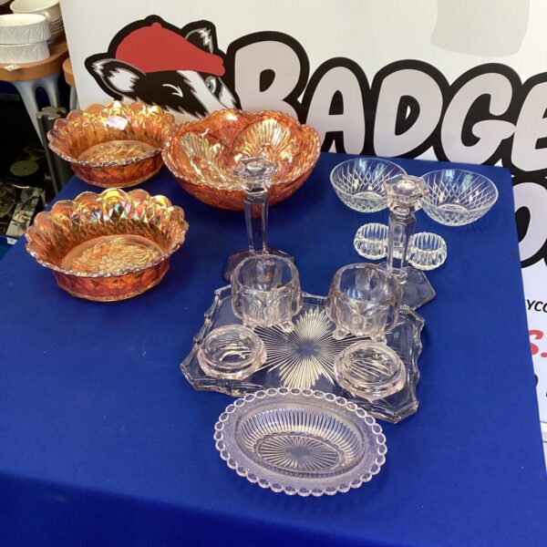 Selection of colourful vintage carnival glass bowls on display.
