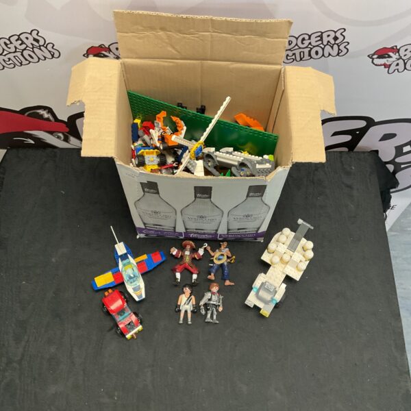 Mixed Lego and Playmobile lot with figures and building blocks.