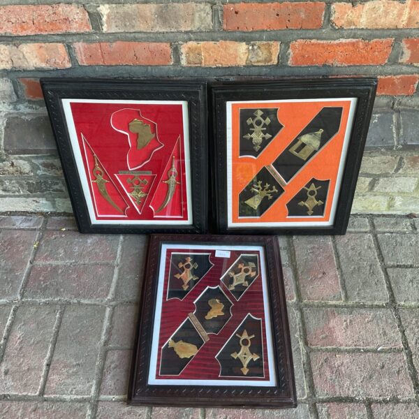 Set of three framed Niger brass art panels with leather frames.