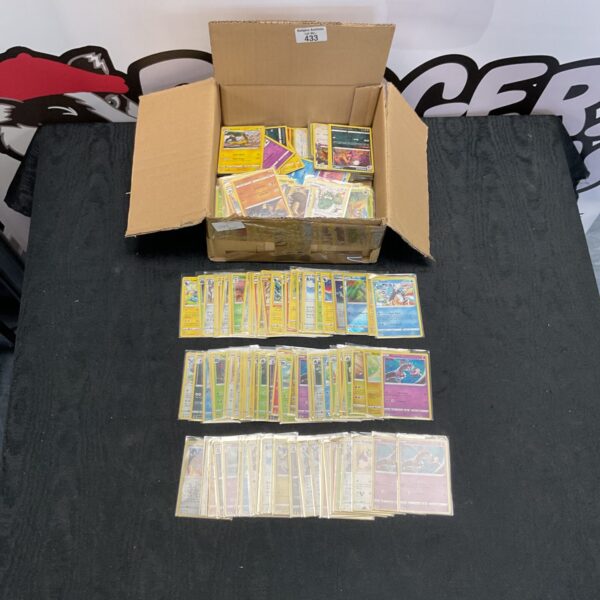 Mixed lot of Pokemon trading cards with holographic cards.