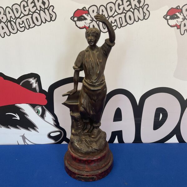 Vintage blacksmith metal sculpture, detailed artisan figurine.
