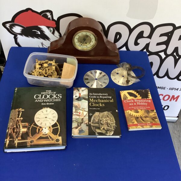 Vintage clock with repair books for horology enthusiasts.