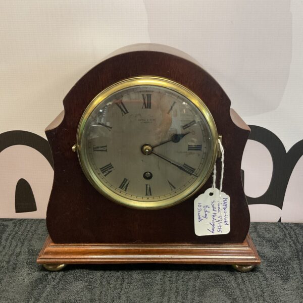 Antique Mappin and Webb mahogany mantle clock with Roman numerals.