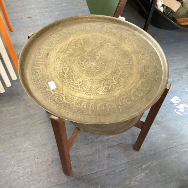 Vintage Islamic brass charger table with intricate geometric design.