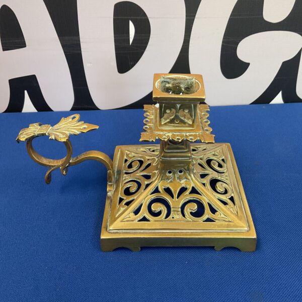 Antique vintage brass chamber stick with pierced design.