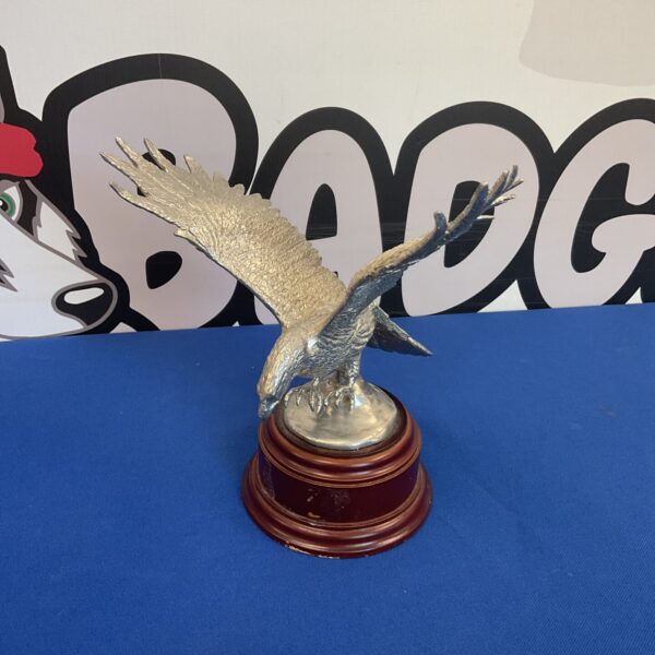 Vintage RAF eagle sculpture on wooden plinth, detailed aviation art.