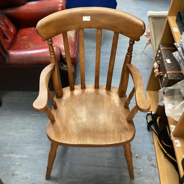 Vintage oak carver chair with shaped back and carved details.