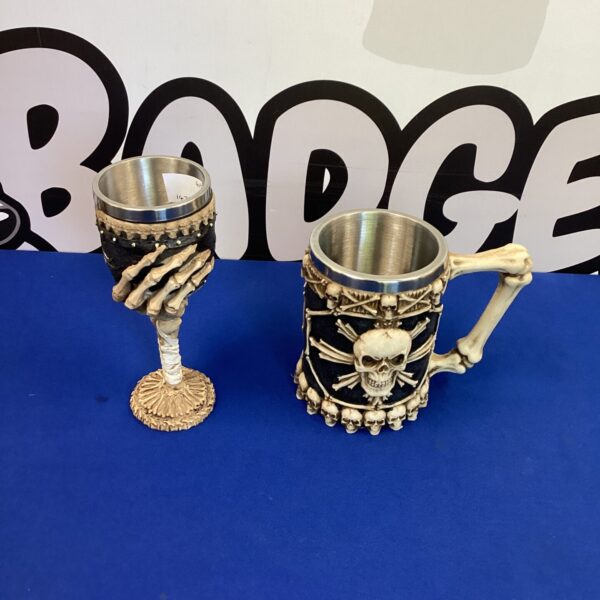 Detailed pirate tankard and goblet set with skull designs.