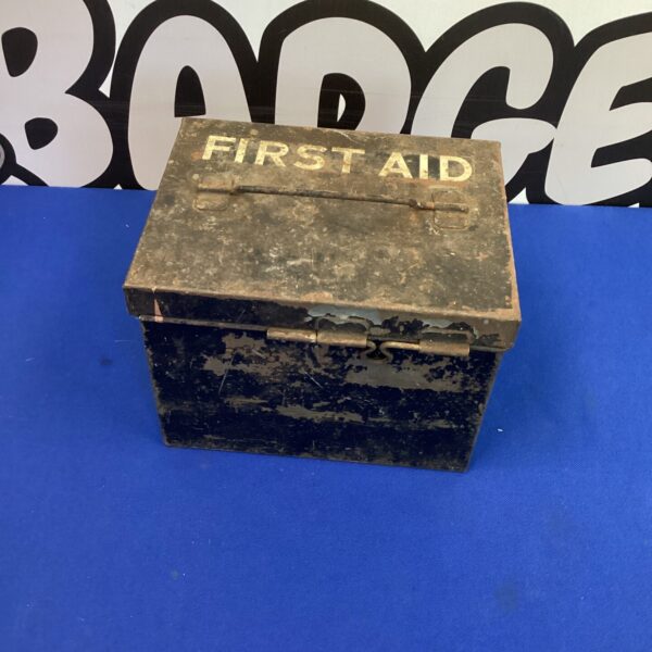 Vintage first aid tin with a worn painted finish.