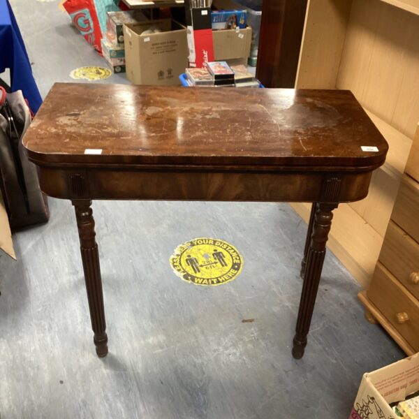 Antique Victorian folding table with mahogany finish.