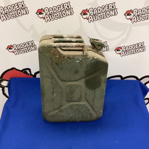 Weathered vintage metal jerry can for fuel storage.