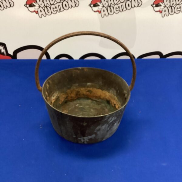 Vintage copper jam pot with handle, ideal for preserving.
