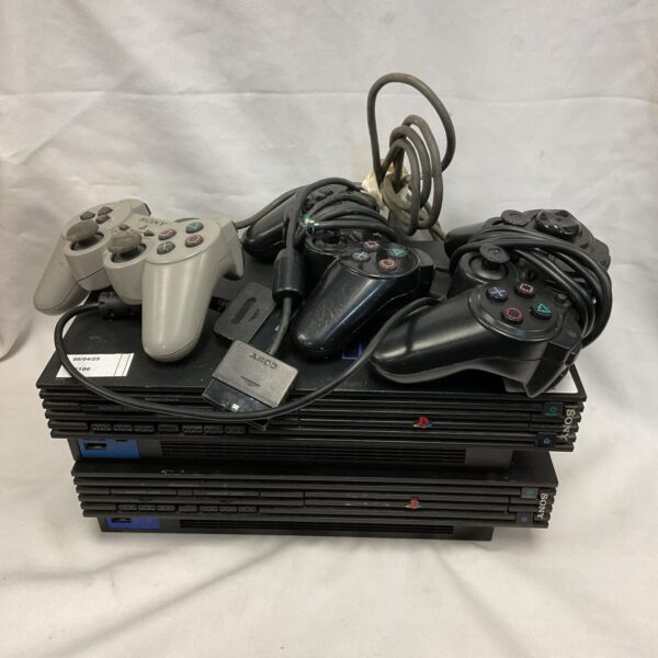 Two Sony PlayStation 2 consoles and controllers for retro gaming.