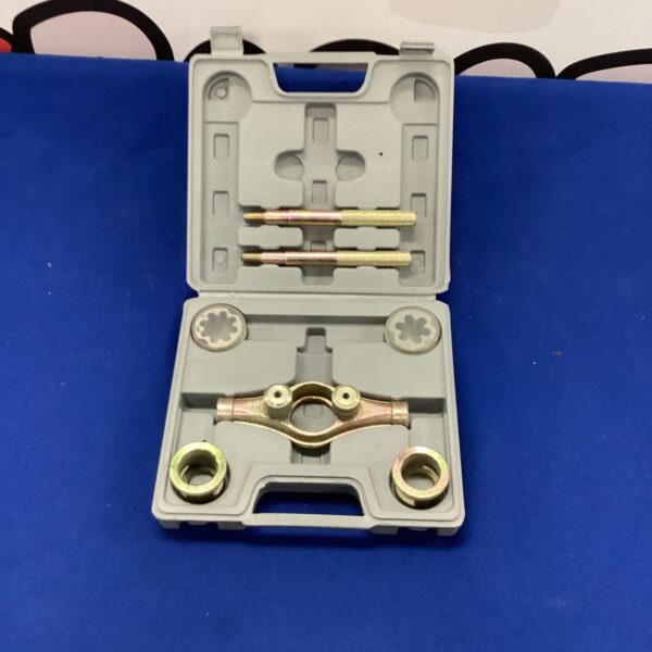 Vintage tap and die set in a plastic case for metalworking.