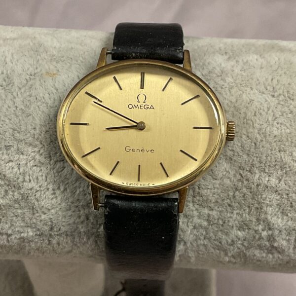 Close-up of vintage Omega Geneve watch dial with gold indices.