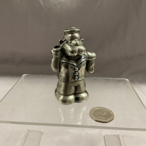 Vintage Popeye cigarette lighter, collectible character memorabilia.