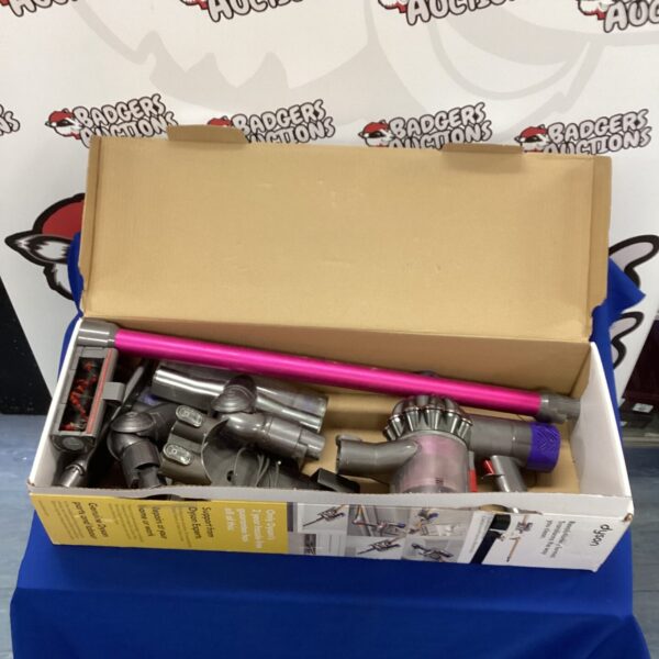 Dyson cordless vacuum cleaner in original box, ready for cleaning.