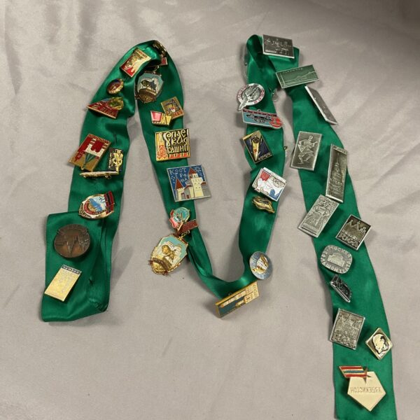 Vintage Russian pin badges collection on green ribbon.