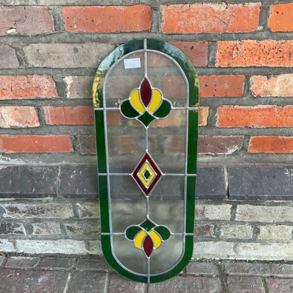 Antique stained glass panel with floral design and diamond motif.