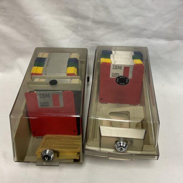 Vintage IBM floppy disks in protective cases, classic computer storage.