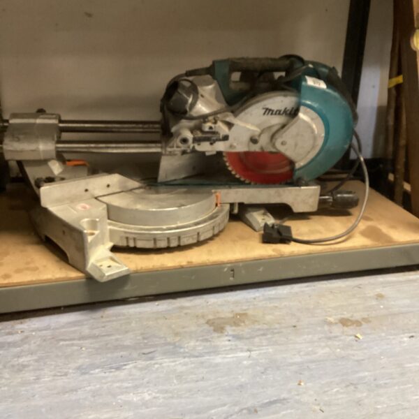 Vintage Makita abrasive chop saw for cutting metal in a workshop.
