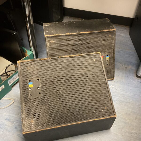 Pair of vintage black wedge stage speakers for live sound.