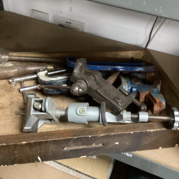 Assorted metal G-clamps for woodworking and metalworking projects.