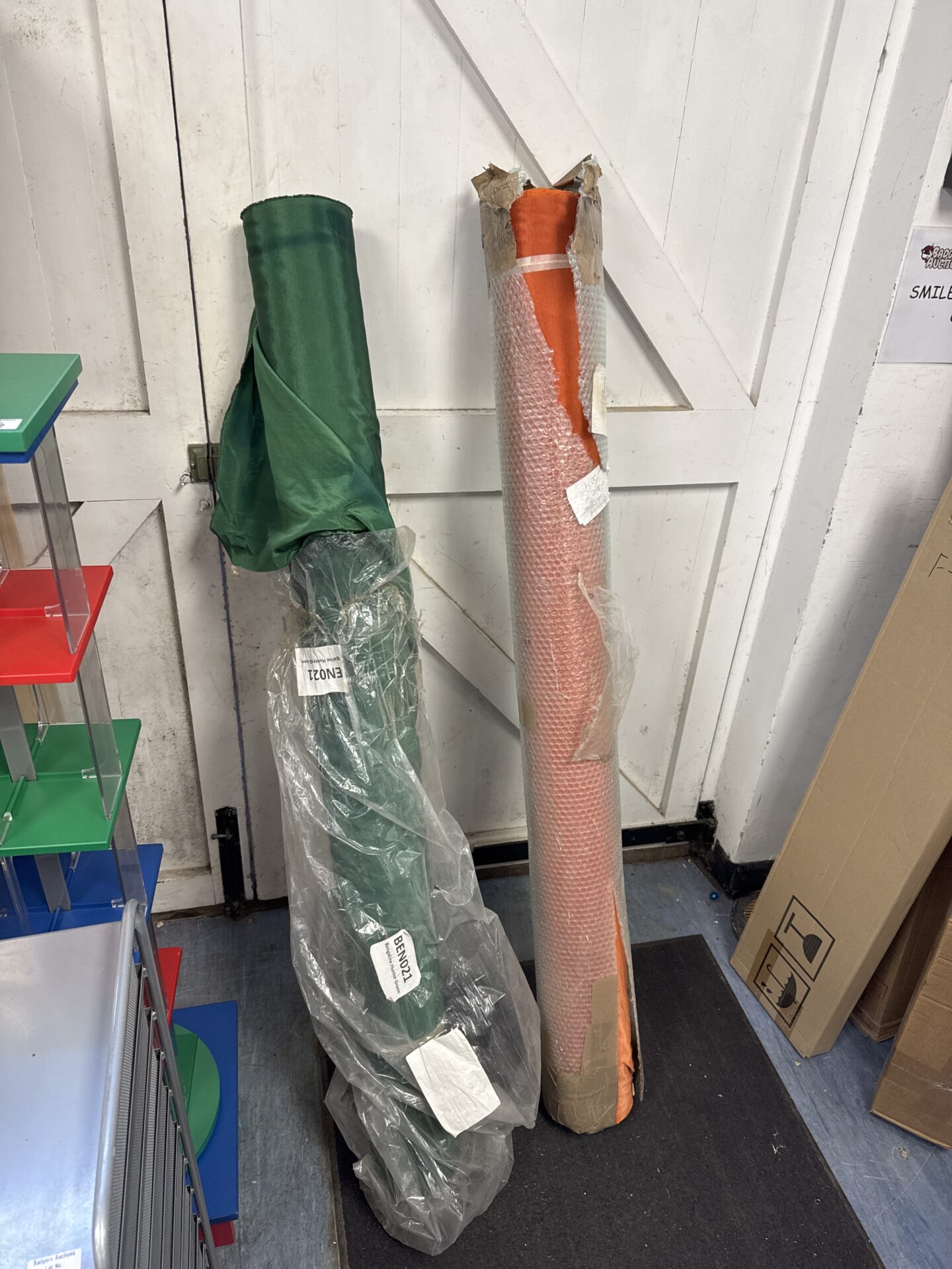 1085 Two large rolls of fabric – orange & green