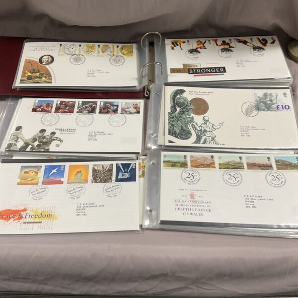 First day covers album showcasing colourful commemorative stamp designs.