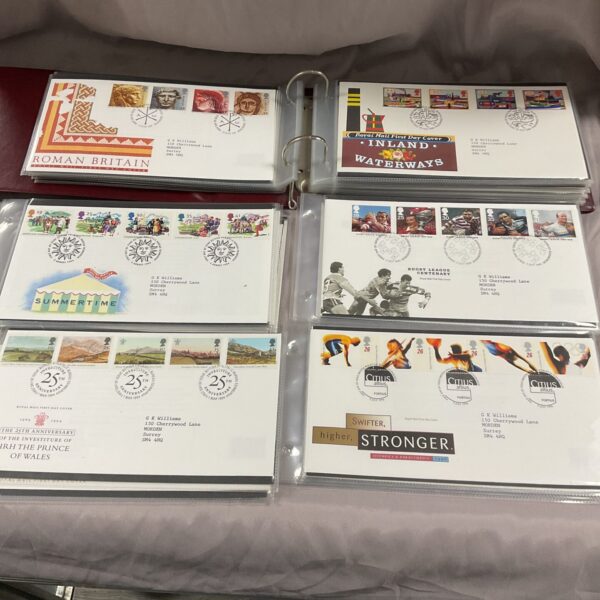 First day covers album with thematic stamp collection visible.