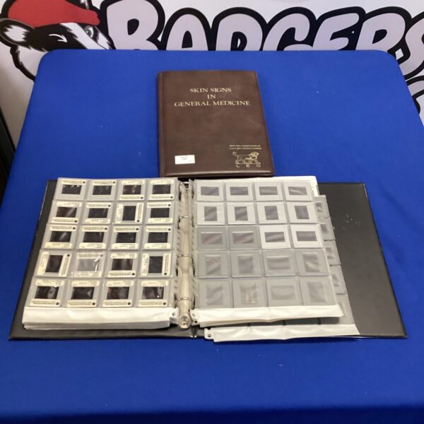 Two folders of 35mm skin signs slides for medical education.