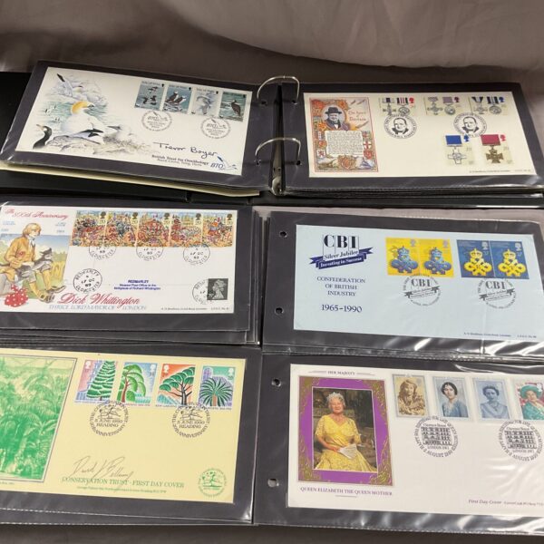 First Day Cover album showcasing British commemorative stamps.