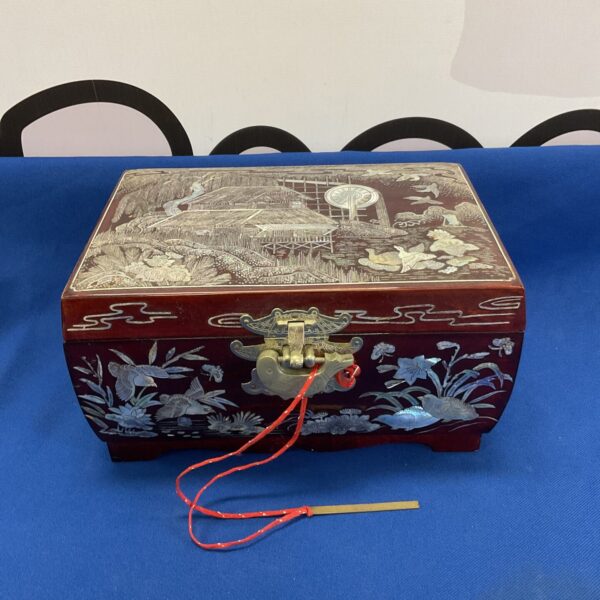 Front view of antique Japanese lacquered jewellery box with mother of pearl inlay.