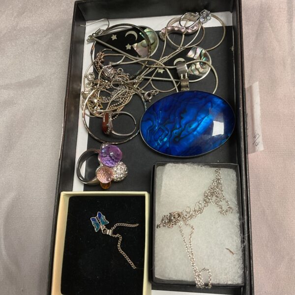 Tray of vintage silver jewellery including a brooch and earrings.