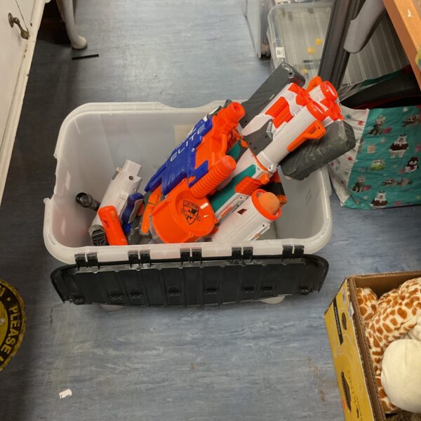 Crate filled with a mixed lot of Nerf guns and parts.