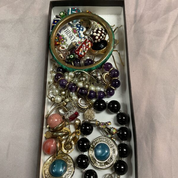 Assorted vintage costume jewellery tray with brooches and necklaces.