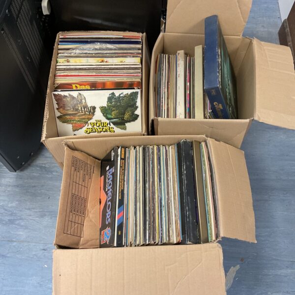 Stack of vinyl record boxes, a large music collection.