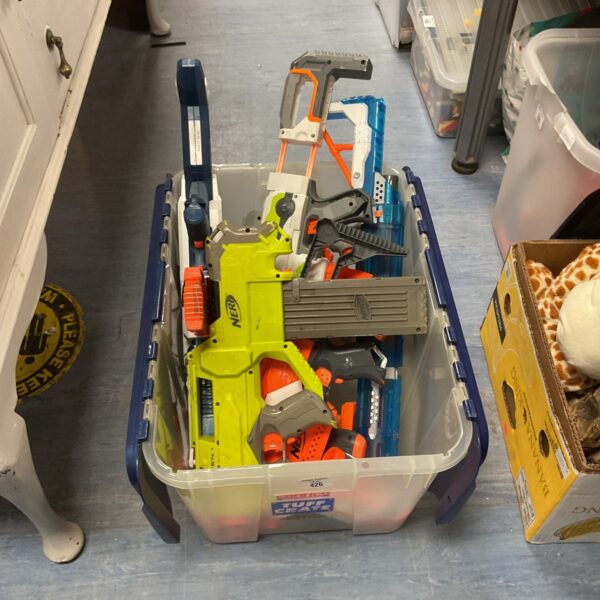 Crate filled with assorted Nerf guns and parts for collectors.